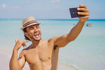 Image showing Man gesturing shaka and taking selfie