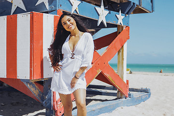 Image showing Content pretty woman posing confidently on beach