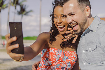 Image showing Diverse bright couple taking selfie