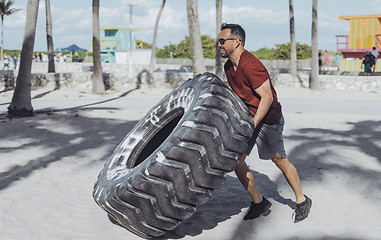 Image showing Man working out with tyre