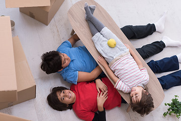 Image showing boys with cardboard boxes around them top view