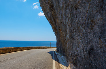 Image showing Asphalt road. Colorful landscape with beautiful mountain road with a perfect asphalt. High rocks, blue sky at sunrise in summer. Vintage toning. Travel background. Highway at mountains