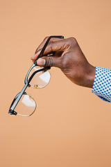 Image showing Male hand holding glasses, isolated