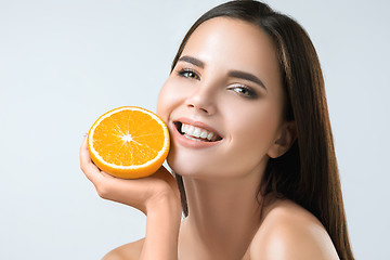 Image showing Beautiful woman\'s face with juicy orange