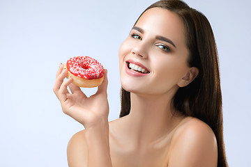 Image showing beautiful woman biting a donut