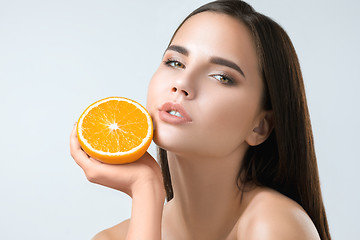 Image showing Beautiful woman\'s face with juicy orange