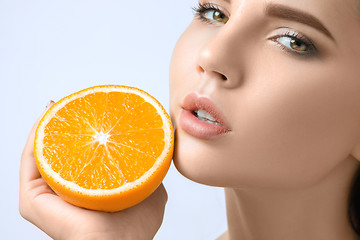 Image showing Beautiful woman\'s face with juicy orange