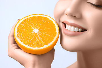 Image showing Beautiful woman\'s face with juicy orange