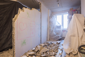 Image showing Reshaping the apartment. Dismantling of walls. Things are covered with a cloth for protection from dust