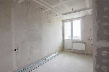 Image showing Interior of the renovated room in a new building, plastered walls, mounted ceiling and cabinet