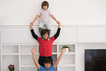 Image showing young boys posing line up piggyback