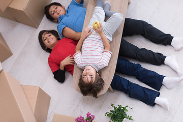 Image showing boys with cardboard boxes around them top view