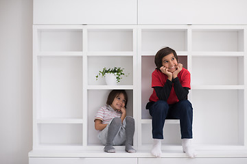 Image showing young boys posing on a shelf