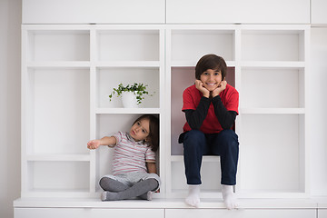 Image showing young boys posing on a shelf