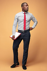 Image showing Attractive standing Afro-American businessman writing notes