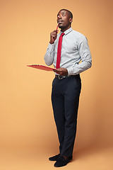 Image showing Attractive standing Afro-American businessman writing notes