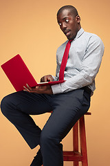 Image showing Handsome Afro American man using a laptop