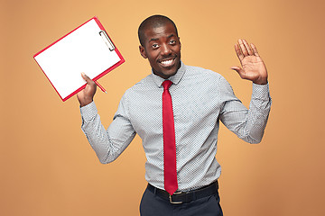 Image showing Attractive standing Afro-American businessman writing notes