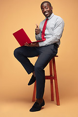 Image showing Handsome Afro American man using a laptop