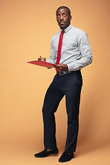 Image showing Attractive standing Afro-American businessman writing notes