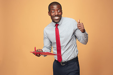 Image showing Attractive standing Afro-American businessman writing notes