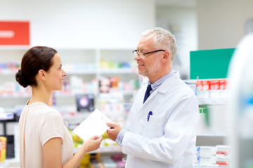 Image showing woman and apothecary with prescription at pharmacy