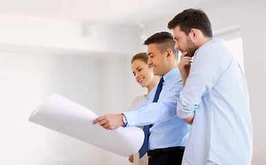 Image showing realtor showing blueprint of new home to couple