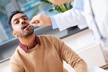 Image showing doctor examining patient throat at clinic