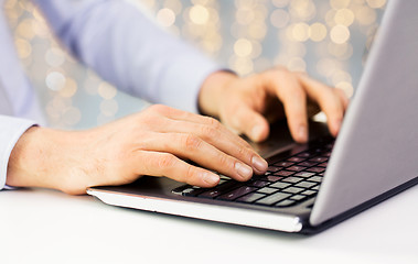 Image showing close up of man typing on laptop keyboard