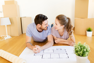 Image showing couple with boxes and blueprint moving to new home