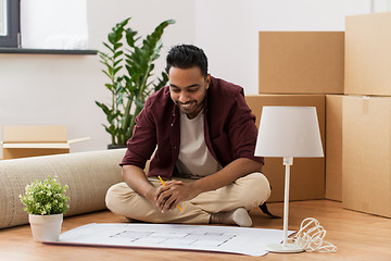 Image showing man with blueprint and boxes moving to new home