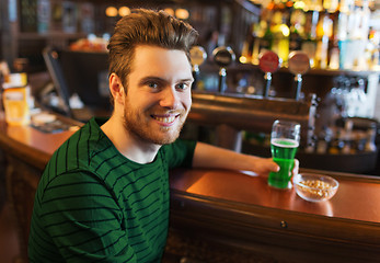 Image showing man drinking green beer at bar or pub