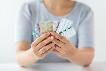 Image showing woman hands holding packs of pills
