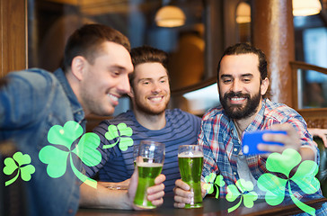 Image showing friends taking selfie with green beer at pub