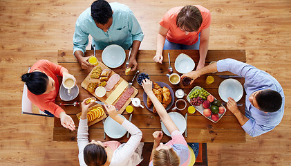 Image showing group of people having breakfast at table