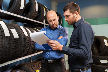 Image showing customer and salesman at car service or auto store