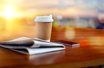 Image showing coffee cup, smartphone and newspaper on table