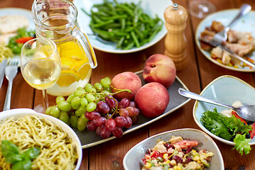 Image showing fruits, salads and pasta on wooden table