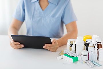 Image showing nurse or doctor with medicines and tablet pc