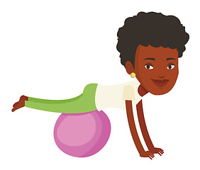 Image showing Young woman exercising with fitball.