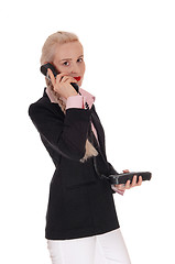 Image showing Business woman talking on an old phone