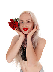 Image showing Smiling woman in portrait with red rose