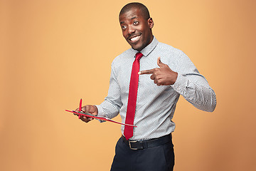 Image showing Attractive standing Afro-American businessman writing notes