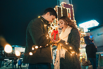 Image showing romantic surprise for Christmas, woman receives a gift from her boyfriend