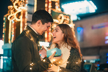 Image showing romantic surprise for Christmas, woman receives a gift from her boyfriend