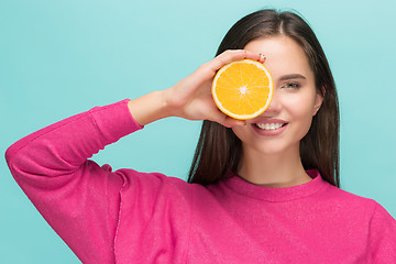 Image showing Beautiful woman\'s face with juicy orange