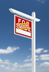 Image showing Left Facing Sold For Sale Real Estate Sign on a Blue Sky with Cl