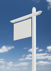 Image showing Blank Real Estate Sign Over A Blue Sky with Clouds.