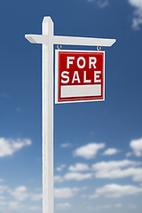 Image showing Right Facing For Sale Real Estate Sign on a Blue Sky with Clouds