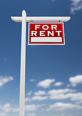 Image showing Right Facing For Rent Real Estate Sign on a Blue Sky with Clouds